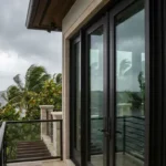 Impact glass doors installed in an oceanfront home in South Florida, providing hurricane protection and unobstructed water views.