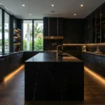 Kitchen High end waterfront kitchen featuring matte black cabinetry, gold hardware, marble countertops, and warm integrated lighting in Florida