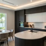 Kitchen Contemporary luxury kitchen with curved island, matte finishes, integrated lighting, and minimalist cabinetry in Florida