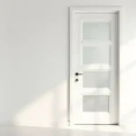White interior door with frosted glass panels in a bright modern home.