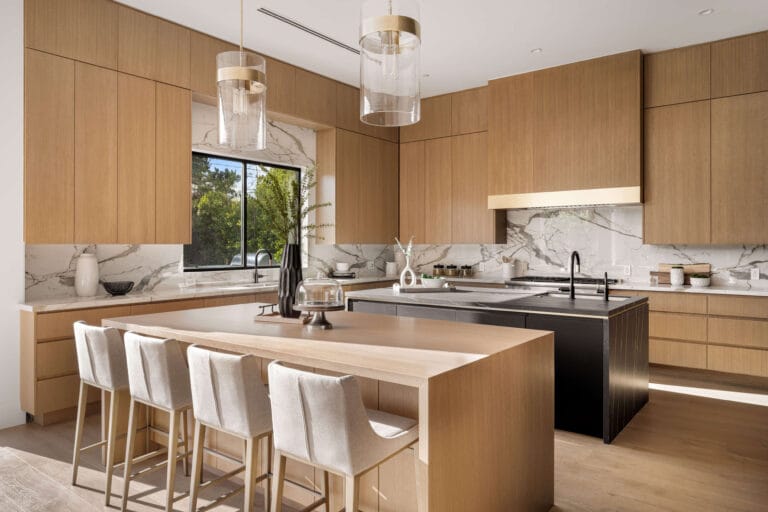 A stunning luxury kitchen with high-end appliances, sleek marble countertops, custom cabinetry, and an expansive island, all bathed in natural light for a sophisticated, modern look.