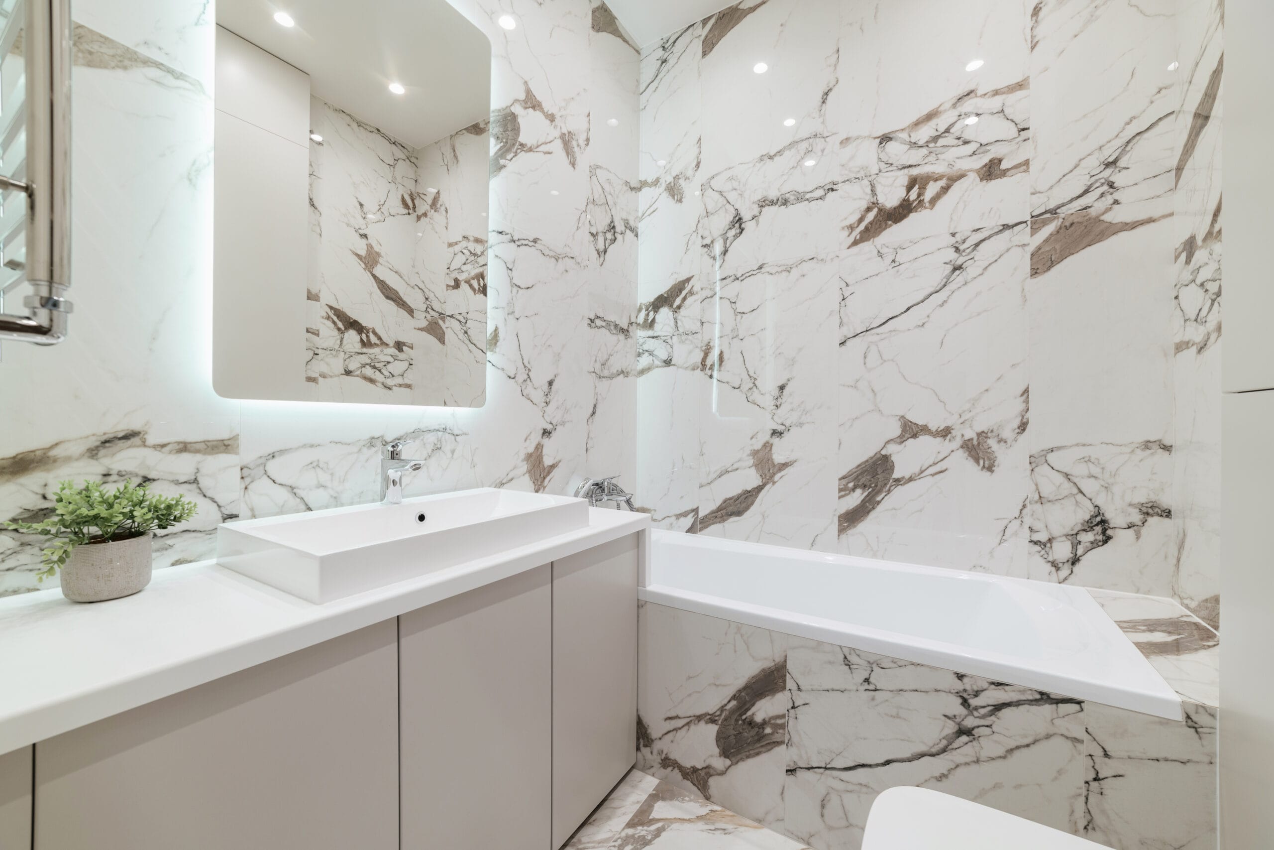 clean bathroom in new interior with white bathtub