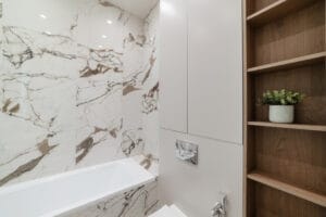 new bathroom interior with white bathtub and wood