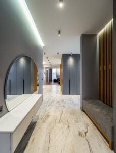interior of luxury house. grey tones. entrance hall. round mirror.