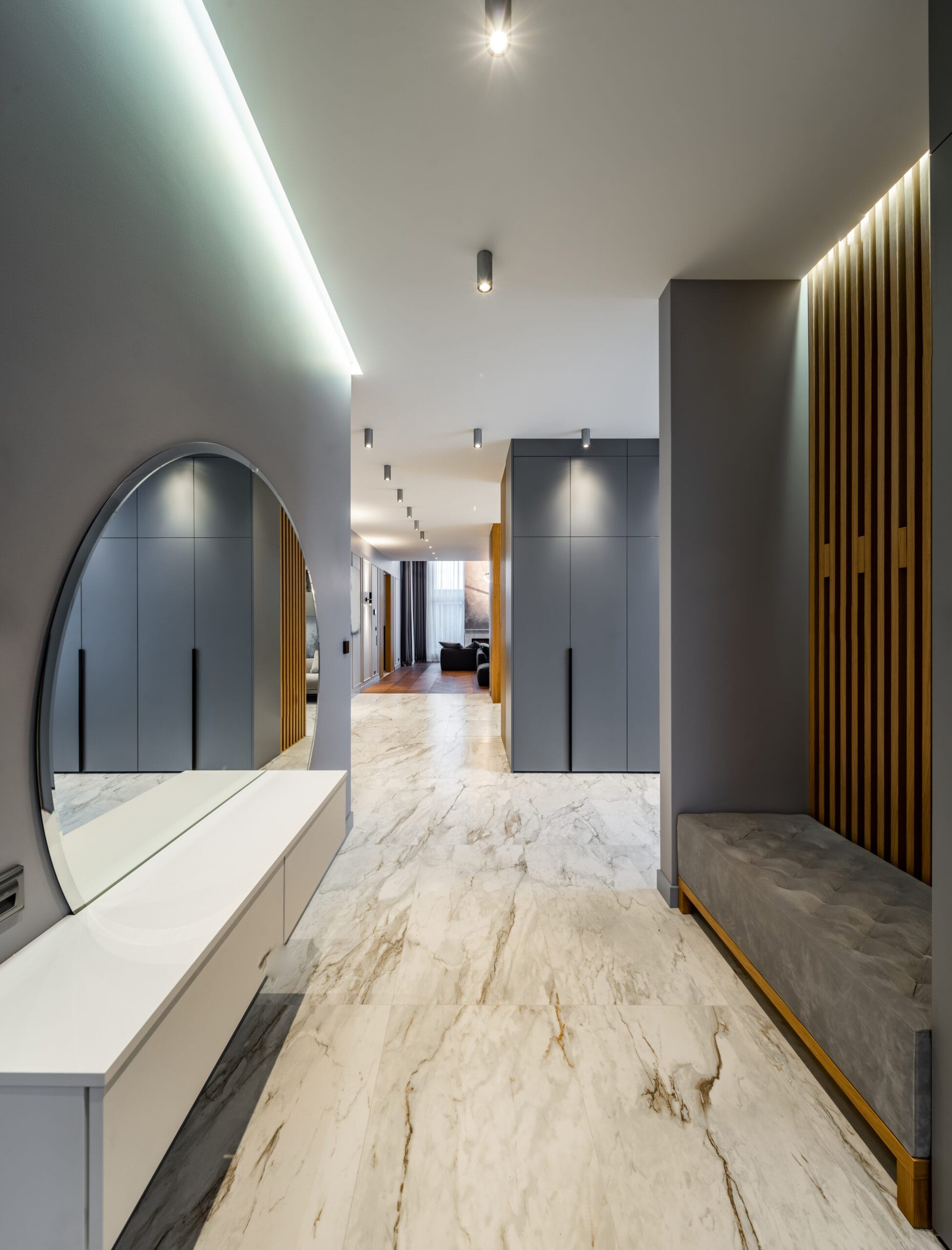 interior of luxury house. grey tones. entrance hall. round mirror.