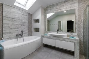 bathroom with a shower cabin, a large mirror and a chrome heater or a radiator of a towel against a white wall. loft style in a new apartment